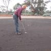 Michael putting at Silver Lake hole, Kambalda